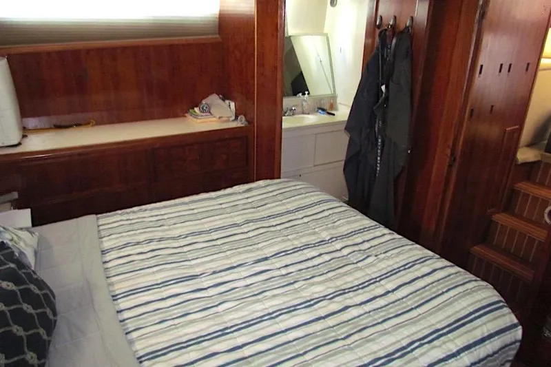  Yacht Photos Pics Interior cabin of 1992 Hatteras 40 Motor Yacht with bed and wooden furnishings.