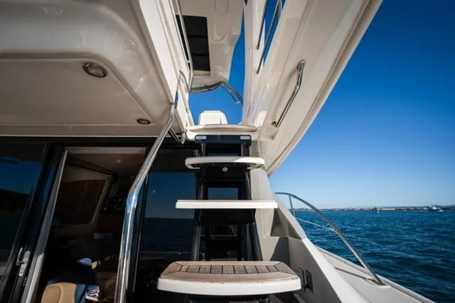  Yacht Photos Pics 2015 Sea Ray 510 Fly yacht stairs with ocean view and clear blue sky.