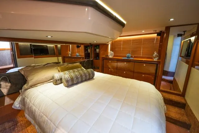  Yacht Photos Pics Luxurious bedroom interior of 2015 Sea Ray 510 Fly yacht with elegant wood finishes.