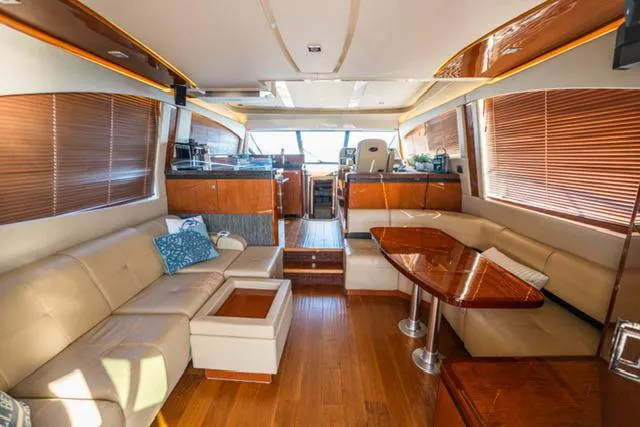  Yacht Photos Pics Luxurious interior of 2015 Sea Ray 510 Fly yacht with elegant seating and wooden finishes.