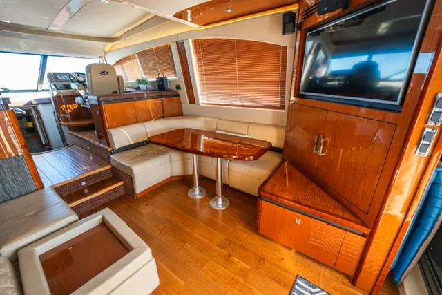  Yacht Photos Pics Luxurious interior of 2015 Sea Ray 510 Fly yacht with wood finishes and seating area.