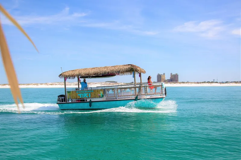 Big Kahuna Yacht Photos Pics Tiki boat cruising on turquoise waters, Beachcat COI Tiki Boat 2022 model.