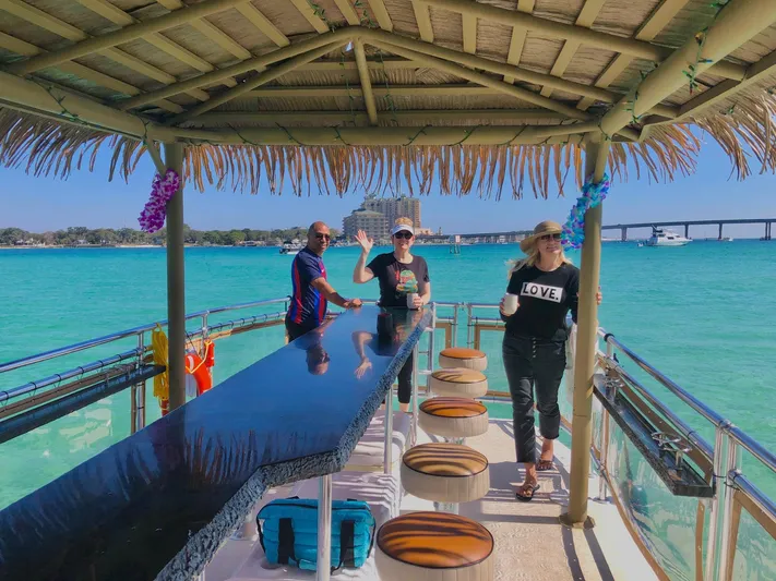 Big Kahuna Yacht Photos Pics Three people enjoying a sunny day on a 2022 Beachcat COI Tiki Boat.