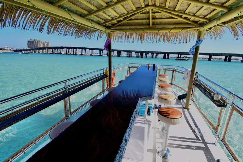 Big Kahuna Yacht Photos Pics Tiki boat with bar seating on turquoise water, 2022 Beachcat COI Tiki Boat.