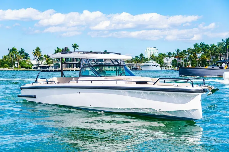 First Byte Yacht Photos Pics 2023 Axopar 37 Sun Top boat cruising on a sunny day in tropical waters.