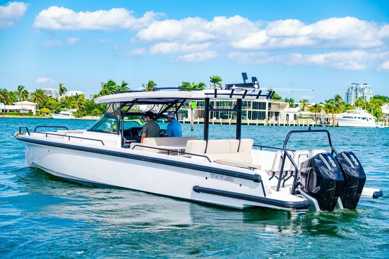 First Byte Yacht Photos Pics 2023 Axopar 37 Sun Top boat cruising on a sunny day with twin engines.