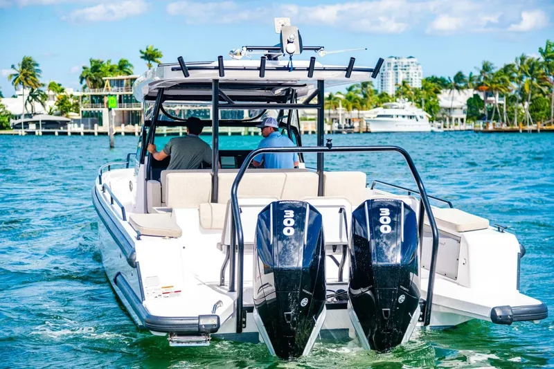 First Byte Yacht Photos Pics 2023 Axopar 37 Sun Top boat cruising on clear blue water.