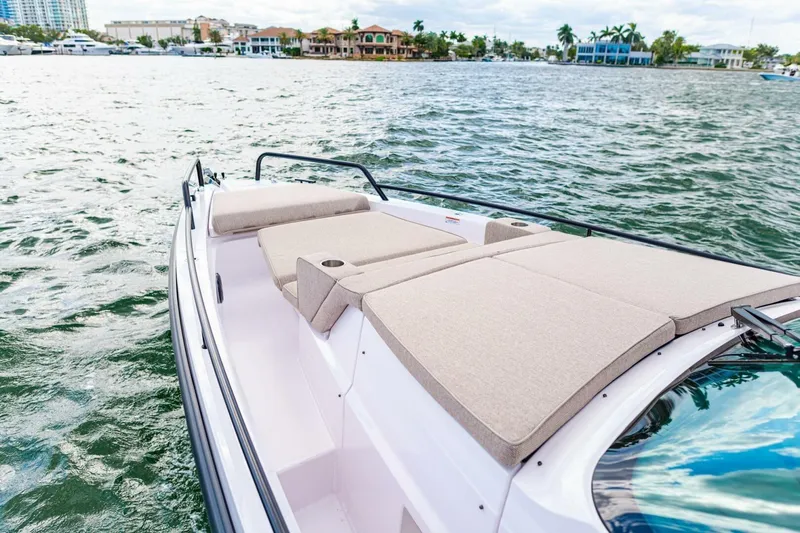 First Byte Yacht Photos Pics 2023 Axopar 37 Sun Top boat with spacious sunbathing area on calm waters.