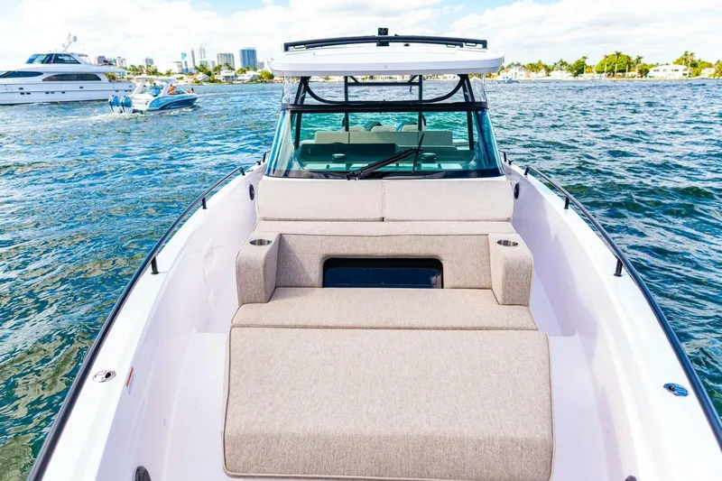 First Byte Yacht Photos Pics 2023 Axopar 37 Sun Top boat with spacious deck and seating on water.