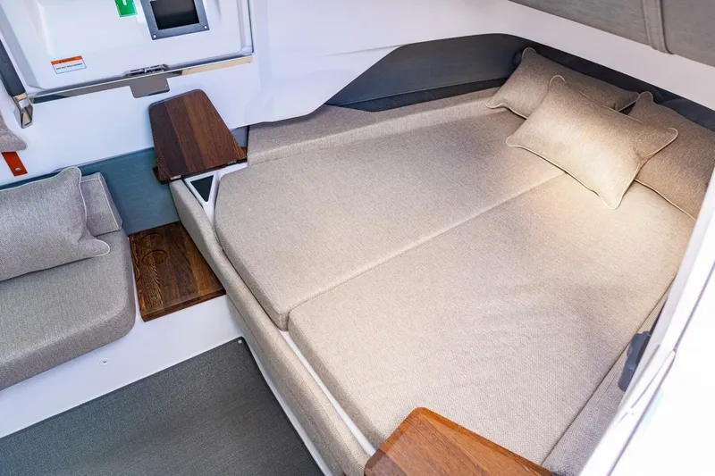 First Byte Yacht Photos Pics Luxurious cabin interior of 2023 Axopar 37 Sun Top with comfortable bedding.