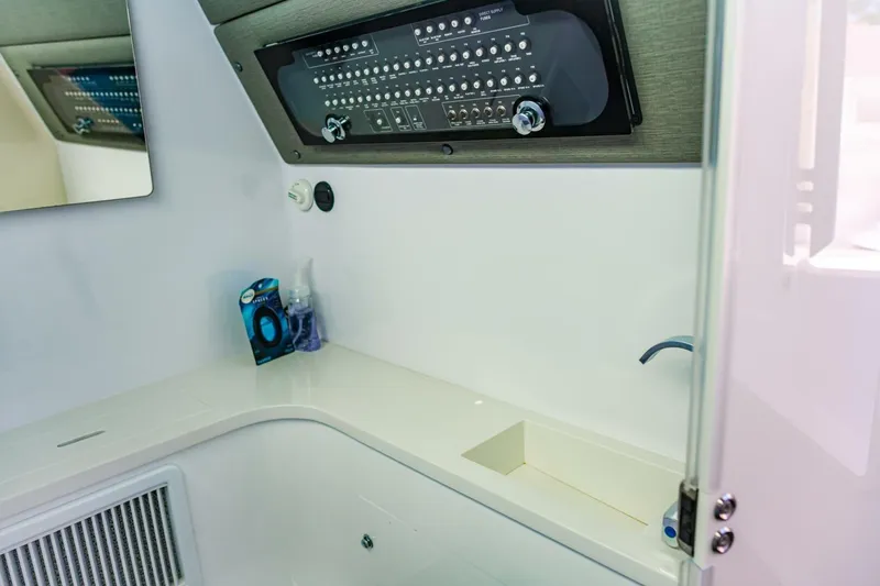 First Byte Yacht Photos Pics 2023 Axopar 37 Sun Top interior with control panel and sink area.