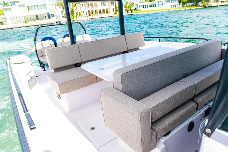 First Byte Yacht Photos Pics 2023 Axopar 37 Sun Top boat with spacious seating and table on deck.