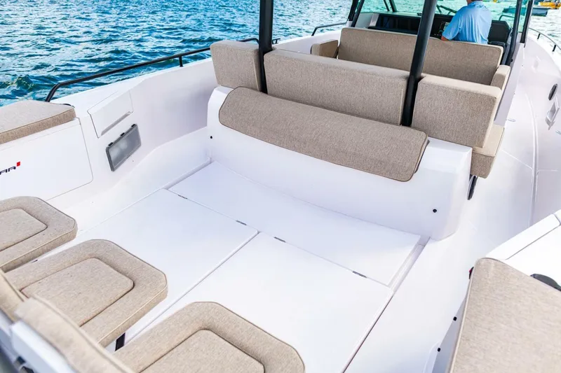 First Byte Yacht Photos Pics 2023 Axopar 37 Sun Top boat interior with beige seating and open deck.