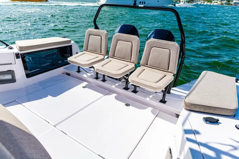 First Byte Yacht Photos Pics 2023 Axopar 37 Sun Top boat interior with cushioned seating and open deck.