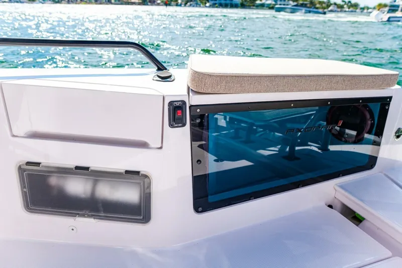 First Byte Yacht Photos Pics 2023 Axopar 37 Sun Top boat interior with seating and storage, on a sunny day.