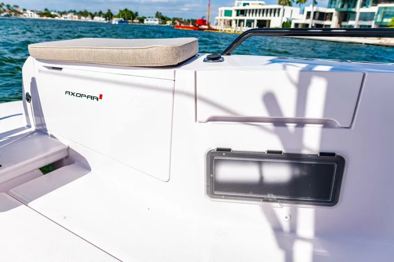 First Byte Yacht Photos Pics 2023 Axopar 37 Sun Top boat detail with seating and storage, on a sunny day.