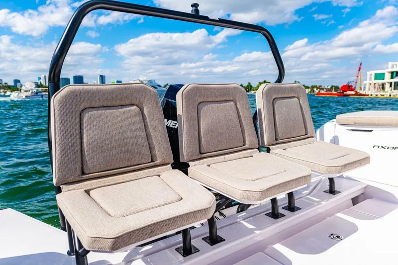 First Byte Yacht Photos Pics 2023 Axopar 37 Sun Top boat seats with ocean view and city skyline.