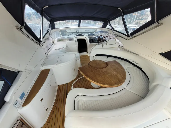 Rmvca Yacht Photos Pics 2004 Fairline Targa 43 yacht interior with white seating and wooden table.