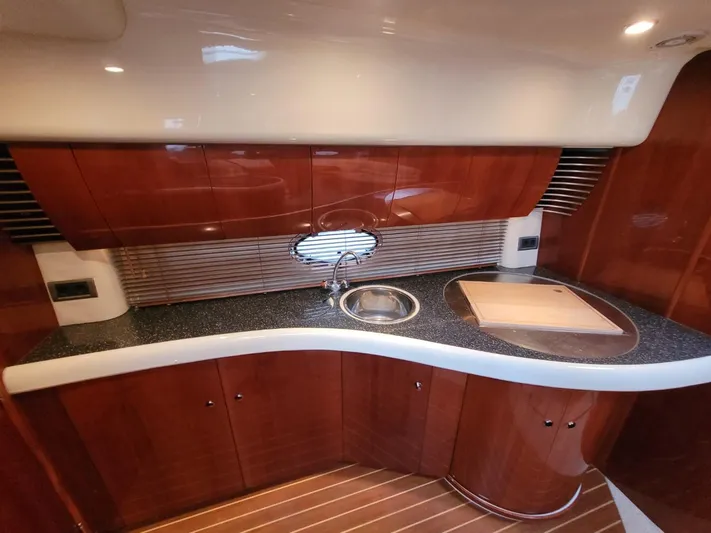 Rmvca Yacht Photos Pics Luxurious 2004 Fairline Targa 43 yacht kitchen with sleek wood cabinetry and modern fixtures.