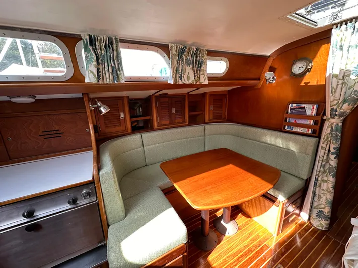  Yacht Photos Pics 1978 Hinckley Bermuda 40 MK III yacht interior with cozy dining area and wooden finishes.