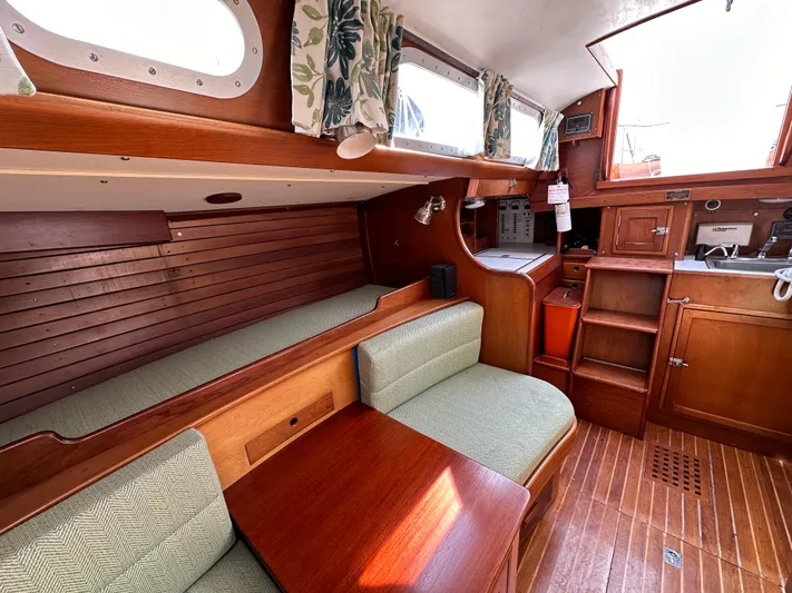 Yacht Photos Pics Interior of 1978 Hinckley Bermuda 40 MK III sailboat with wood finish and seating area.