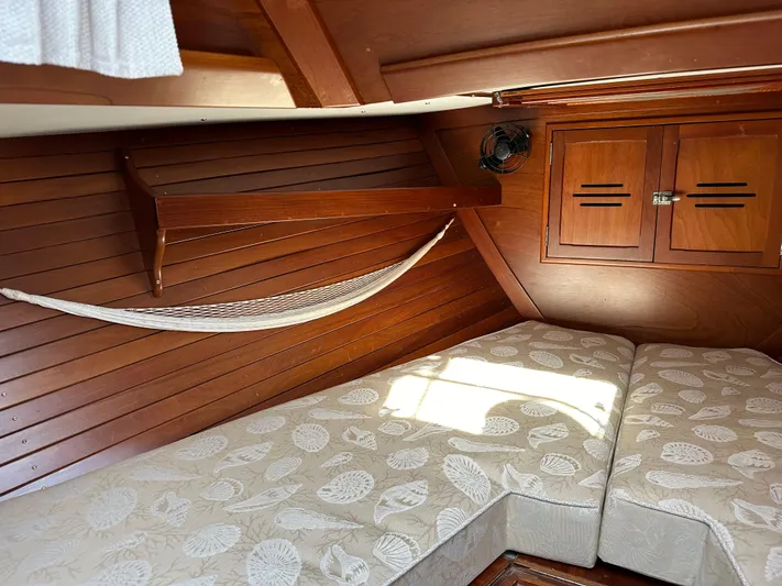  Yacht Photos Pics Interior of 1978 Hinckley Bermuda 40 MK III with wooden paneling and cushioned seating.