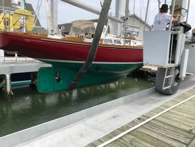  Yacht Photos Pics 1978 Hinckley Bermuda 40 MK III sailboat being lifted from the water at a marina.