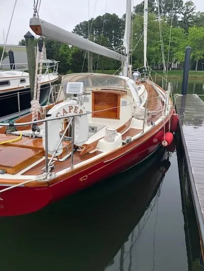  Yacht Photos Pics 1978 Hinckley Bermuda 40 MK III sailboat docked, featuring a red hull and wooden deck.