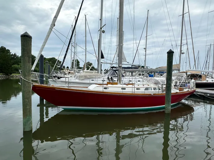  Yacht Photos Pics 1978 Hinckley Bermuda 40 MK III sailboat docked in a marina, reflecting on calm water.