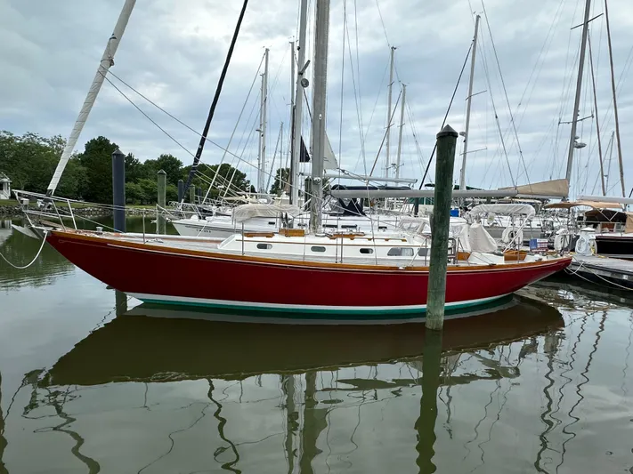  Yacht Photos Pics 1978 Hinckley Bermuda 40 MK III sailboat docked in a marina, featuring a red hull.