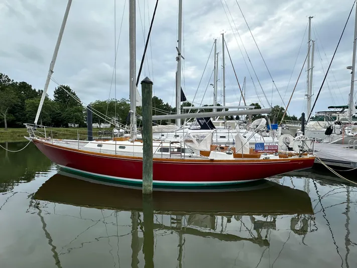  Yacht Photos Pics 1978 Hinckley Bermuda 40 MK III sailboat docked in a marina, reflecting on calm water.