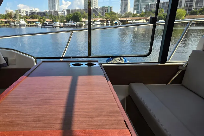  Yacht Photos Pics Interior view of 2020 Jeanneau NC 1095 boat with waterfront cityscape.