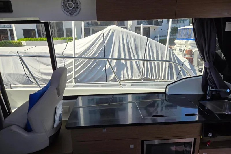  Yacht Photos Pics Interior view of 2020 Jeanneau NC 1095 boat with modern kitchen and window.