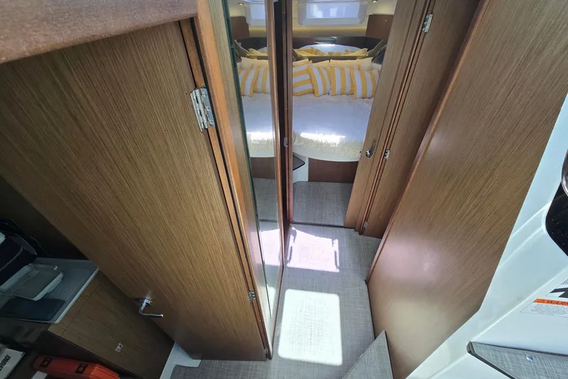  Yacht Photos Pics Interior of 2020 Jeanneau NC 1095 boat with cozy cabin and wooden finish.