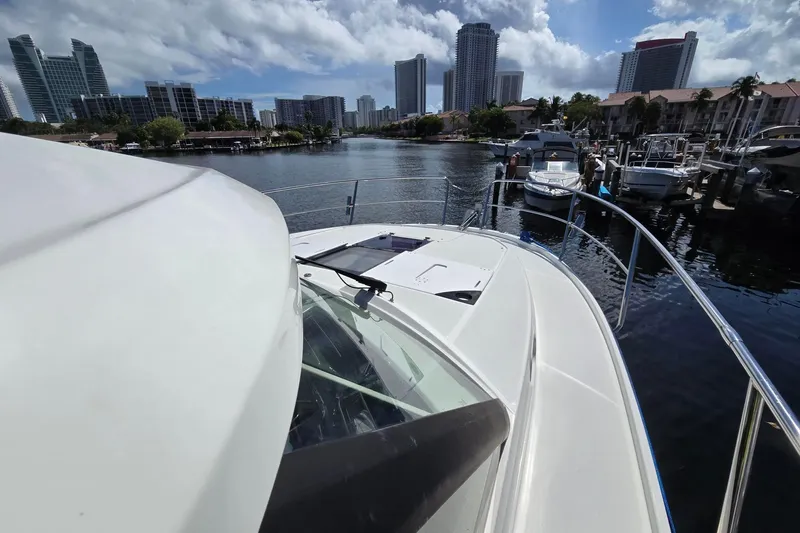 Yacht Photos Pics 2020 Jeanneau NC 1095 boat docked in a marina with city skyline.