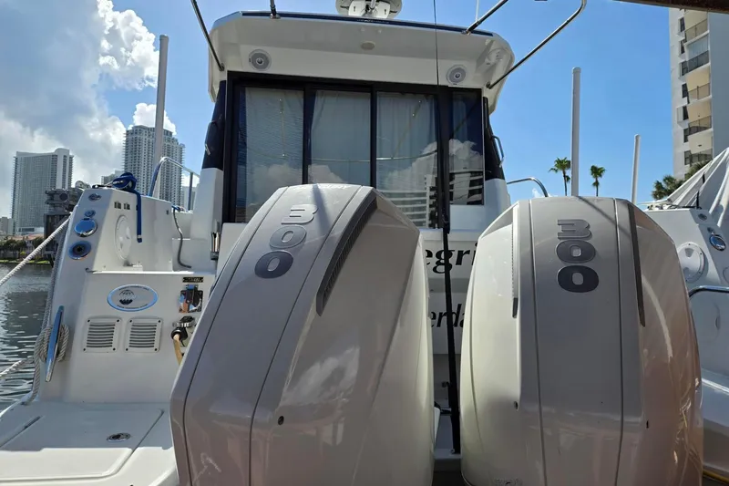  Yacht Photos Pics 2020 Jeanneau NC 1095 boat with dual 300 horsepower engines, docked in a marina.