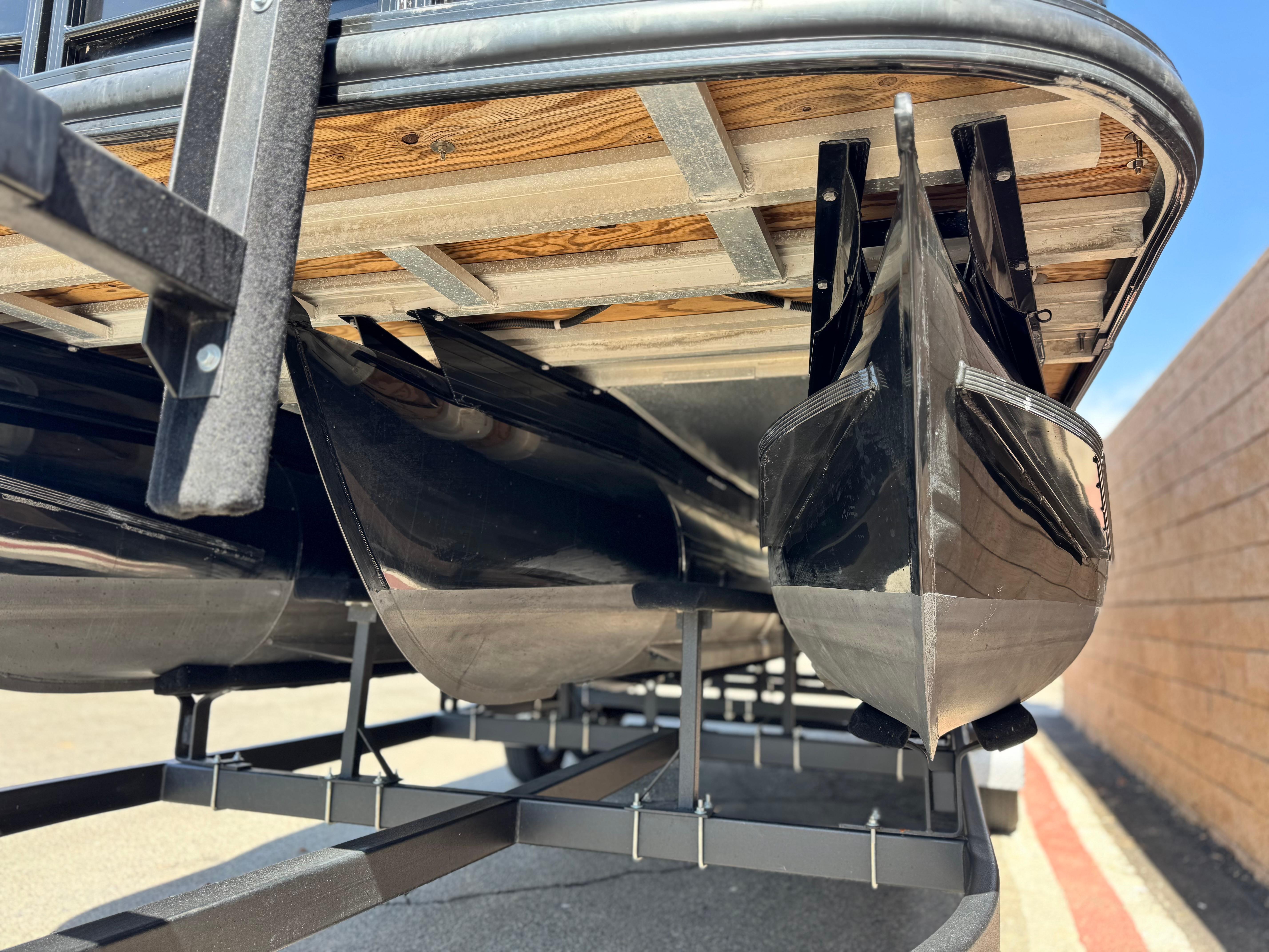 Underside view of 2021 Regency 230 LE3 pontoon boat on trailer.