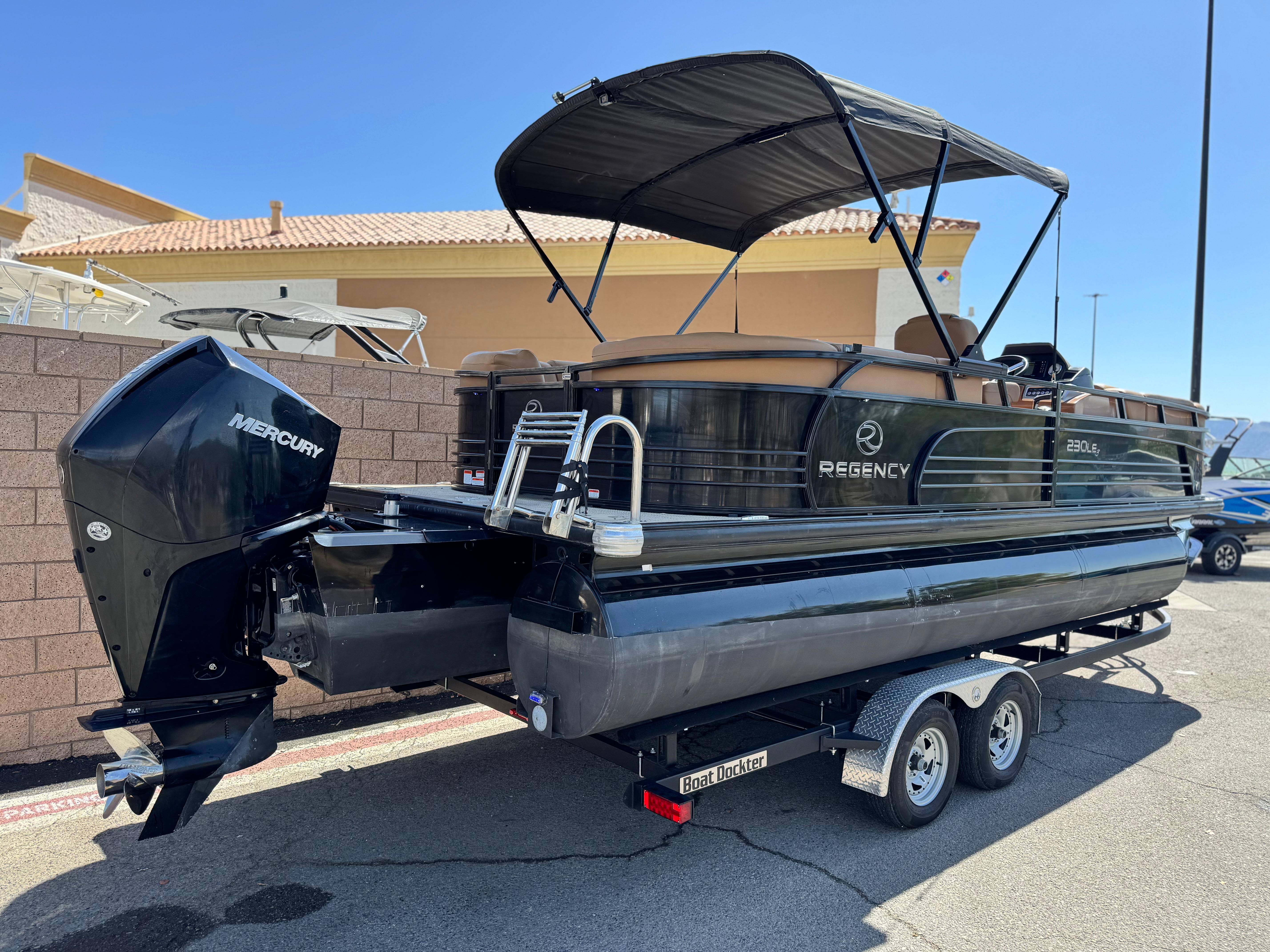 2021 Regency 230 LE3 pontoon boat with Mercury engine on a trailer.