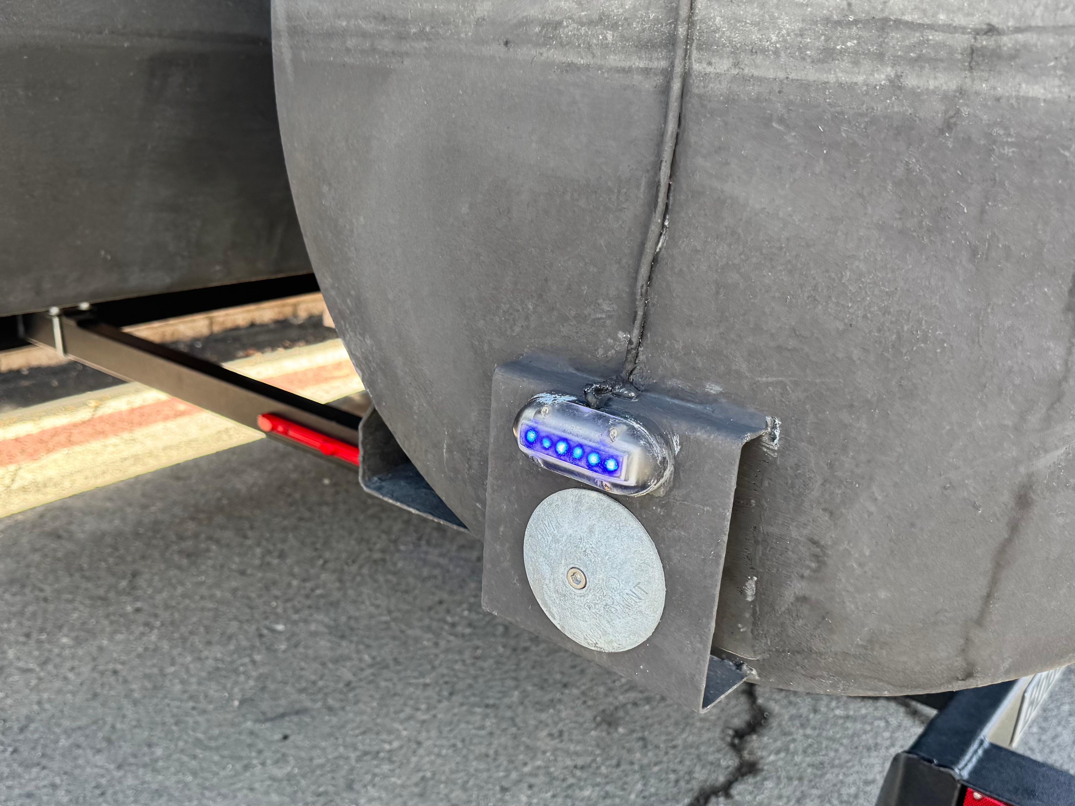 2021 Regency 230 LE3 pontoon boat with blue LED light and metal fixture.