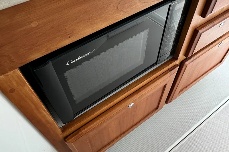 "flying Low" Yacht Photos Pics Built-in microwave in 2008 Back Cove 33 boat's wooden cabinetry.