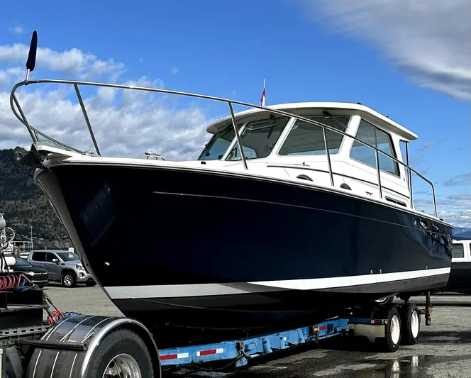 "flying Low" Yacht Photos Pics 2008 Back Cove 33 boat on trailer, parked outdoors under a partly cloudy sky.