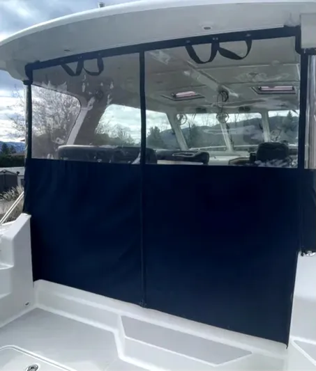 "flying Low" Yacht Photos Pics 2008 Back Cove 33 boat with covered cockpit area and clear windows.