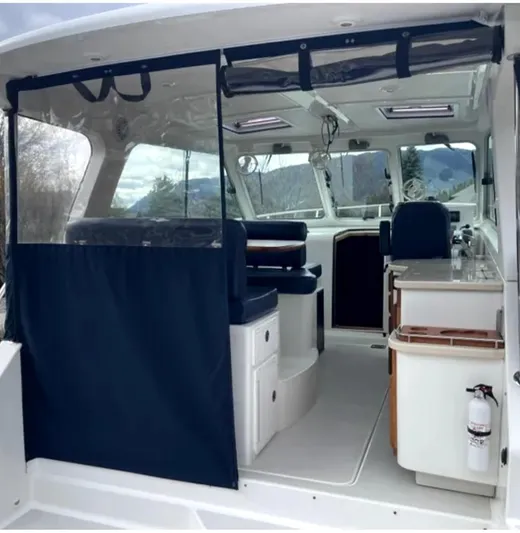 "flying Low" Yacht Photos Pics 2008 Back Cove 33 boat interior with seating, kitchenette, and panoramic windows.