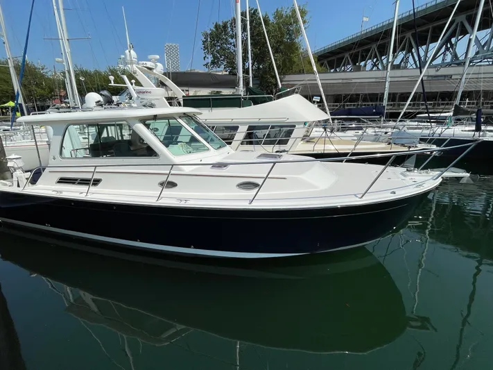 "flying Low" Yacht Photos Pics 2008 Back Cove 33 yacht docked in marina, surrounded by other boats.