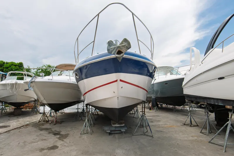  Yacht Photos Pics 2014 Four Winns V375 boat on stands in a marina, surrounded by other vessels.