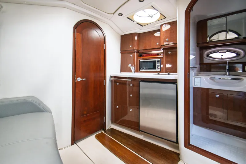 Yacht Photos Pics Luxurious 2014 Four Winns V375 yacht interior with kitchenette, wood cabinetry, and modern appliances.