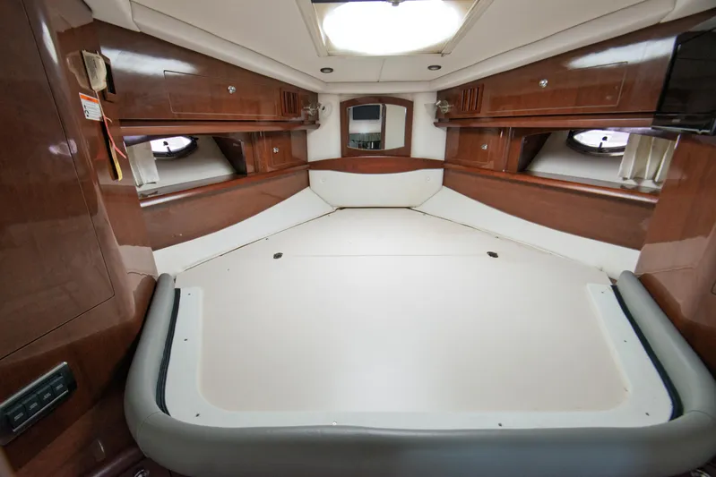  Yacht Photos Pics Interior cabin of 2014 Four Winns V375 boat with wood paneling and portholes.