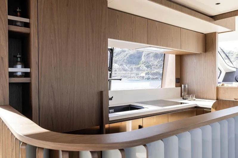  Yacht Photos Pics Luxurious kitchen interior of 2025 Azimut Fly 72 yacht with modern wood finish.