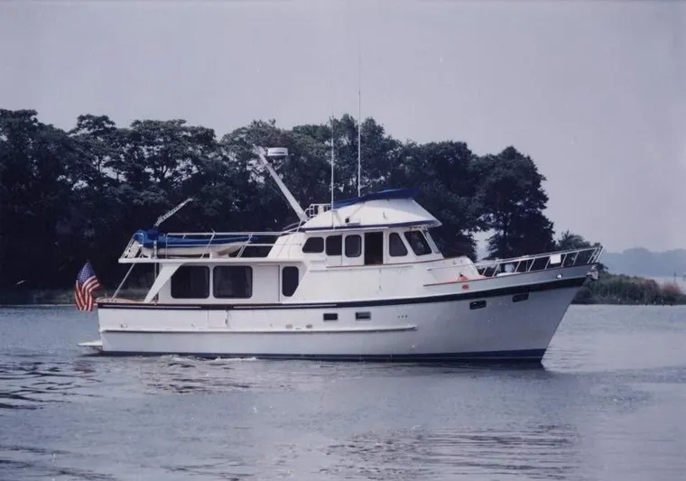 Patient Lady Yacht Photos Pics 1987 DeFever 49 Pilothouse yacht on calm water.