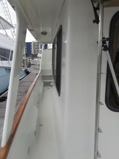 Patient Lady Yacht Photos Pics Side deck of 1987 DeFever 49 Pilothouse yacht in harbor.